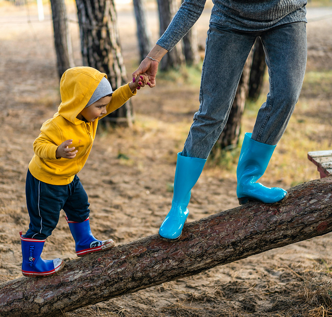 Mother helping child balance